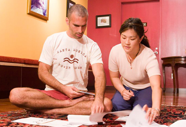 Bryan Kest and Christine Fang discussing Power Yoga business strategy at Santa Monica Power Yoga studio, highlighting the donation-based model and grassroots entrepreneurship.