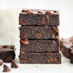 Stack of fudgy cottage cheese protein brownies showing moist texture.