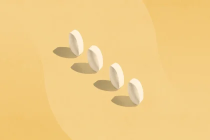four white pills standing on end with shadows
