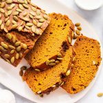 Sliced Starbucks pumpkin bread on a white plate showing fluffy, moist texture.