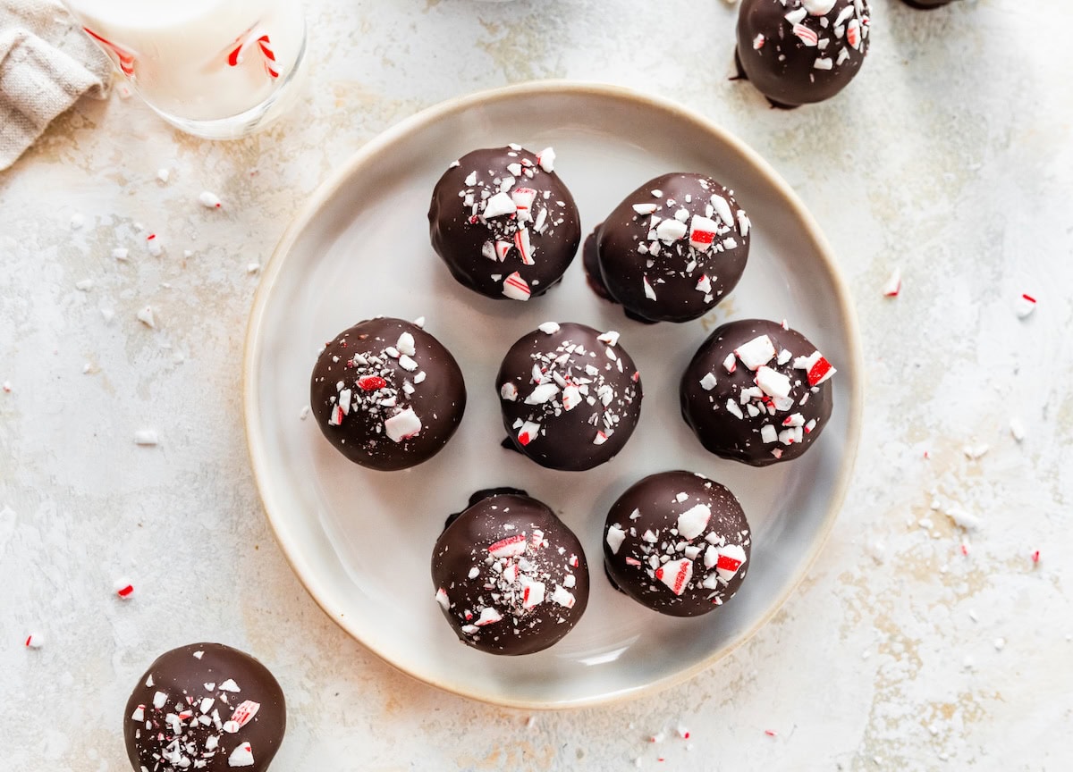 Close-up overhead shot of chocolate peppermint protein balls arranged on a plate.