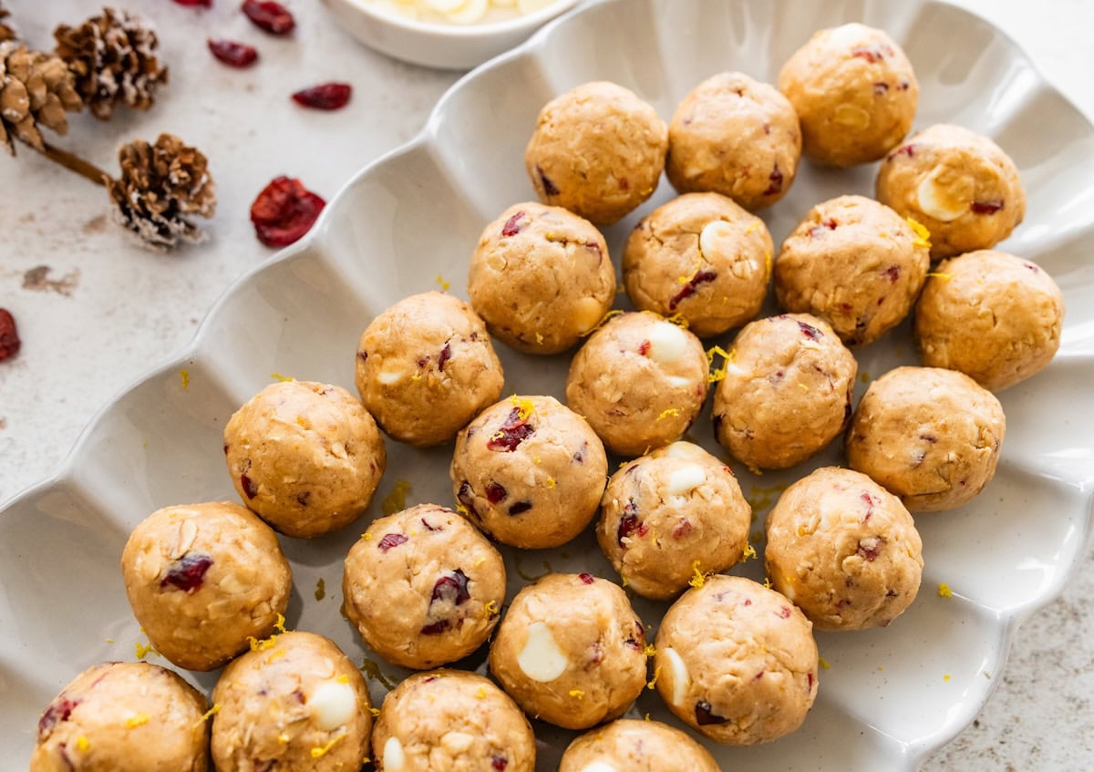 A white dish of cranberry orange protein balls.