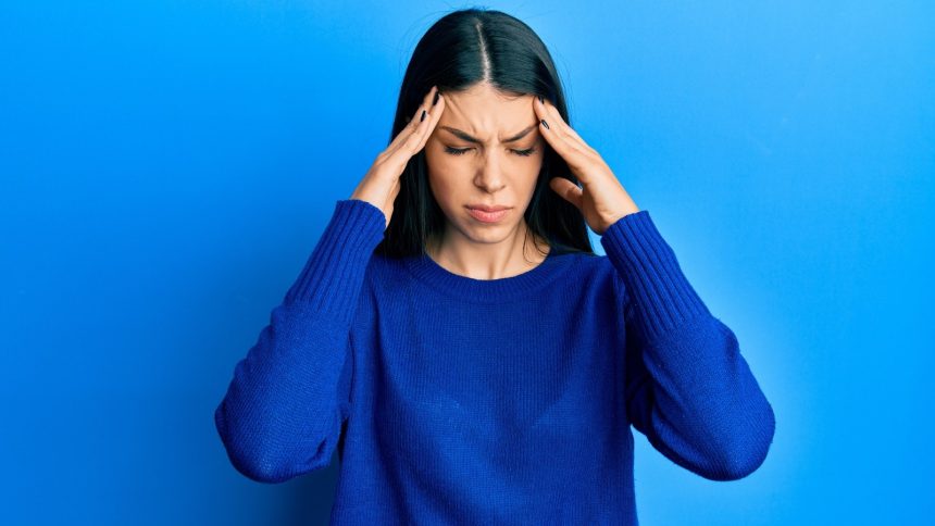 Why do some migraines cause flashing lights or temporary blindness?