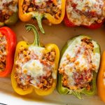 A pan of cooked turkey stuffed peppers with melted cheese.
