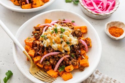 Roasted sweet potatoes topped with ground beef, street corn salsa, pickled red onions, cilantro and hot honey.